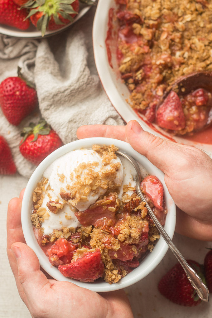 This vegan strawberry crisp is bursting with juicy strawberries, sweetened with maple syrup, and topped with a decadent oat-crumble topping
