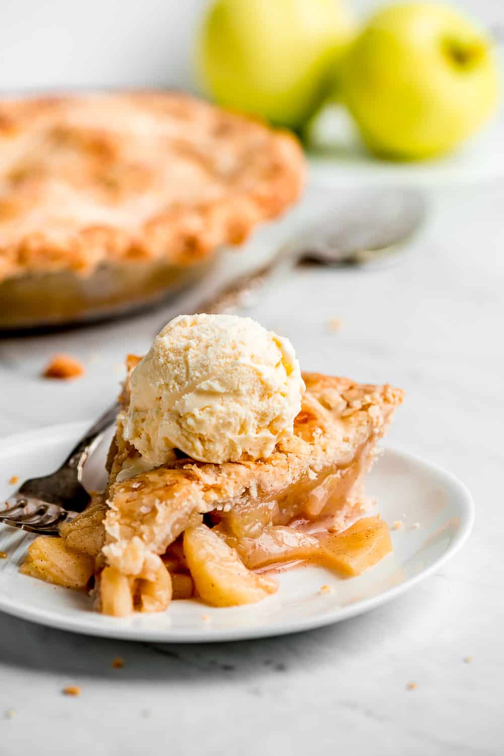 Apple Pie is a classic American favorite that is sure to hit everyone’s dining room table each fall. The buttery flaky crust, sweet-tart apple filling, and warm cinnamon aroma makes this a slice of heaven