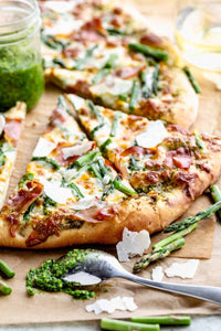 If you think of asparagus as only a side dish, think again! It can be the star of the dinner table when used as a pizza topping! I’ve paired it with pesto, Italian cheeses and crispy prosciutto for a fantastic 30 minute dinner!